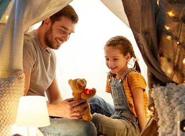 Three people talking around a table with coffee
