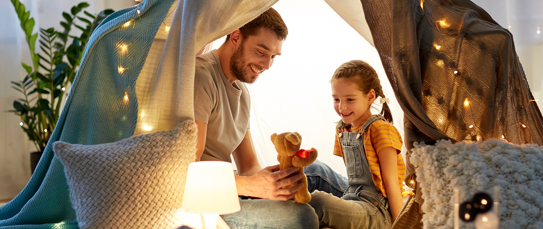 Three people talking around a table with coffee